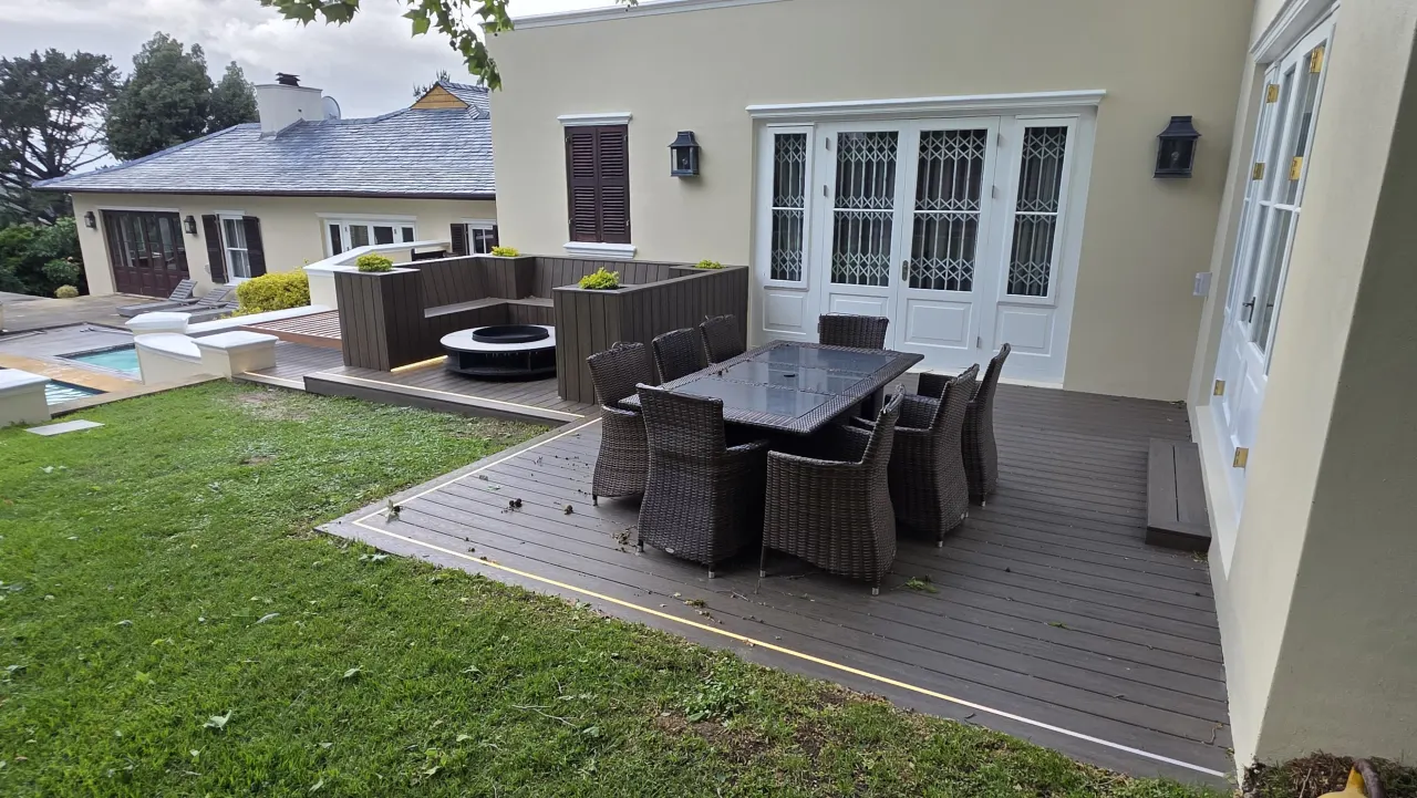 Deck dining area beside French doors