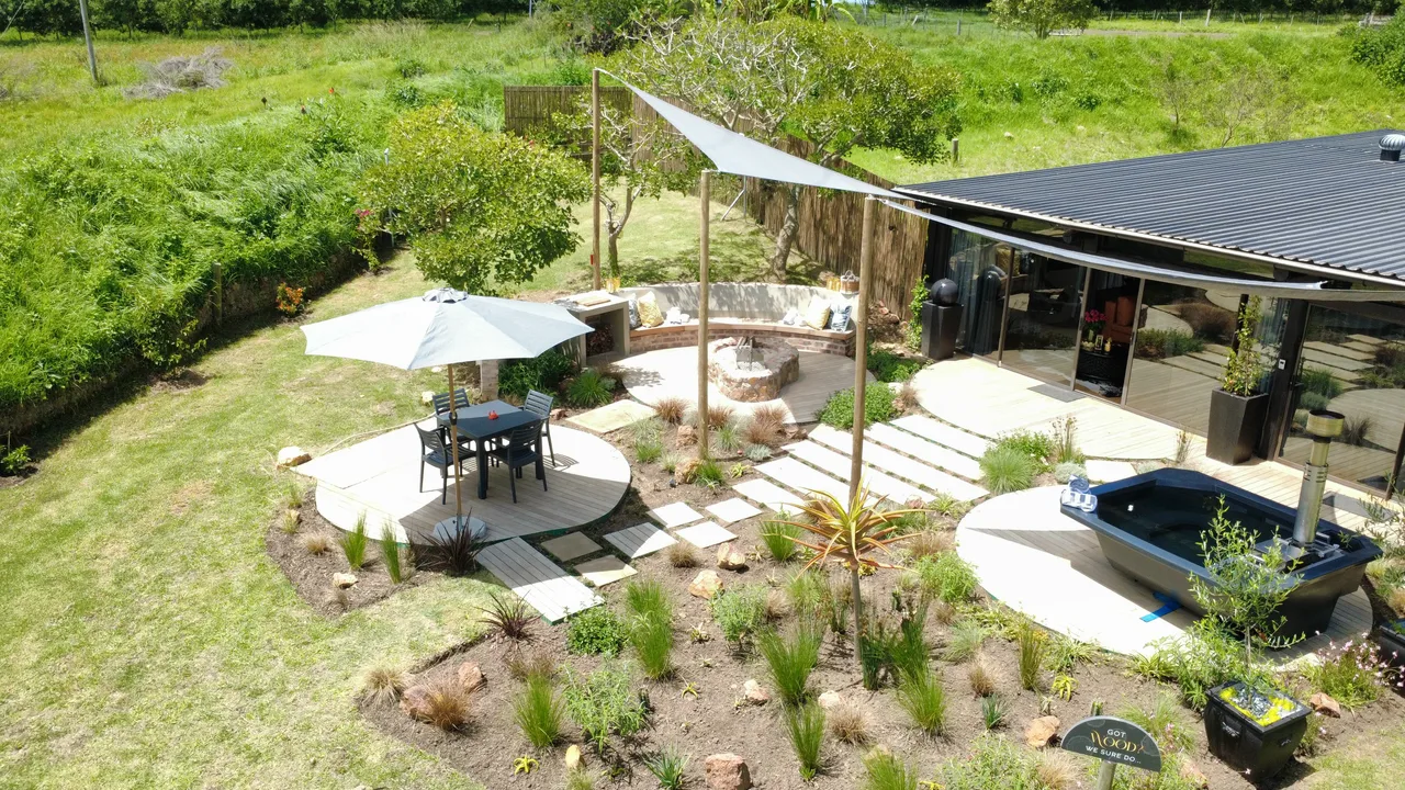 Garden suite — Aerial view of the garden suite with a shade sail, umbrella and circular timber decks