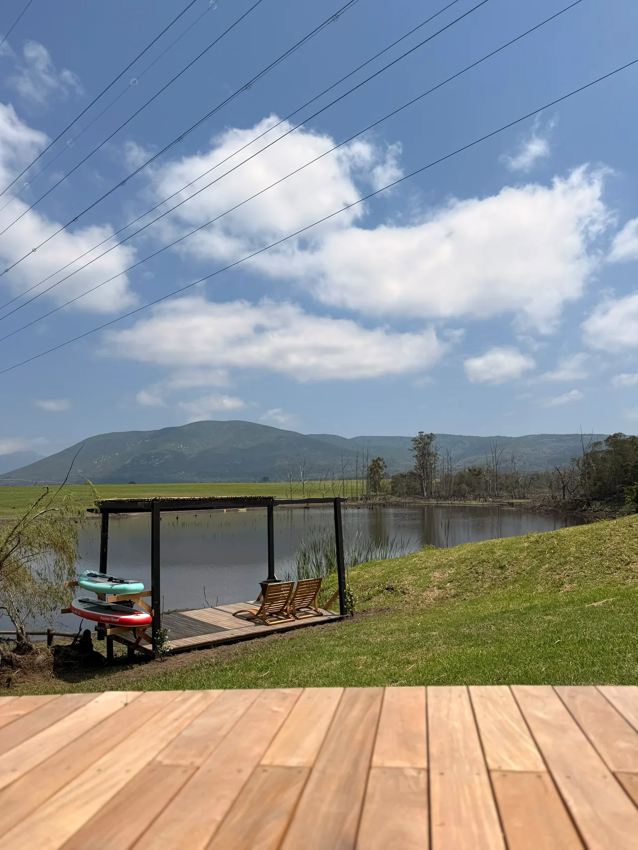 Garden suite — Timber deck and lake-side pergola with the lake beyond