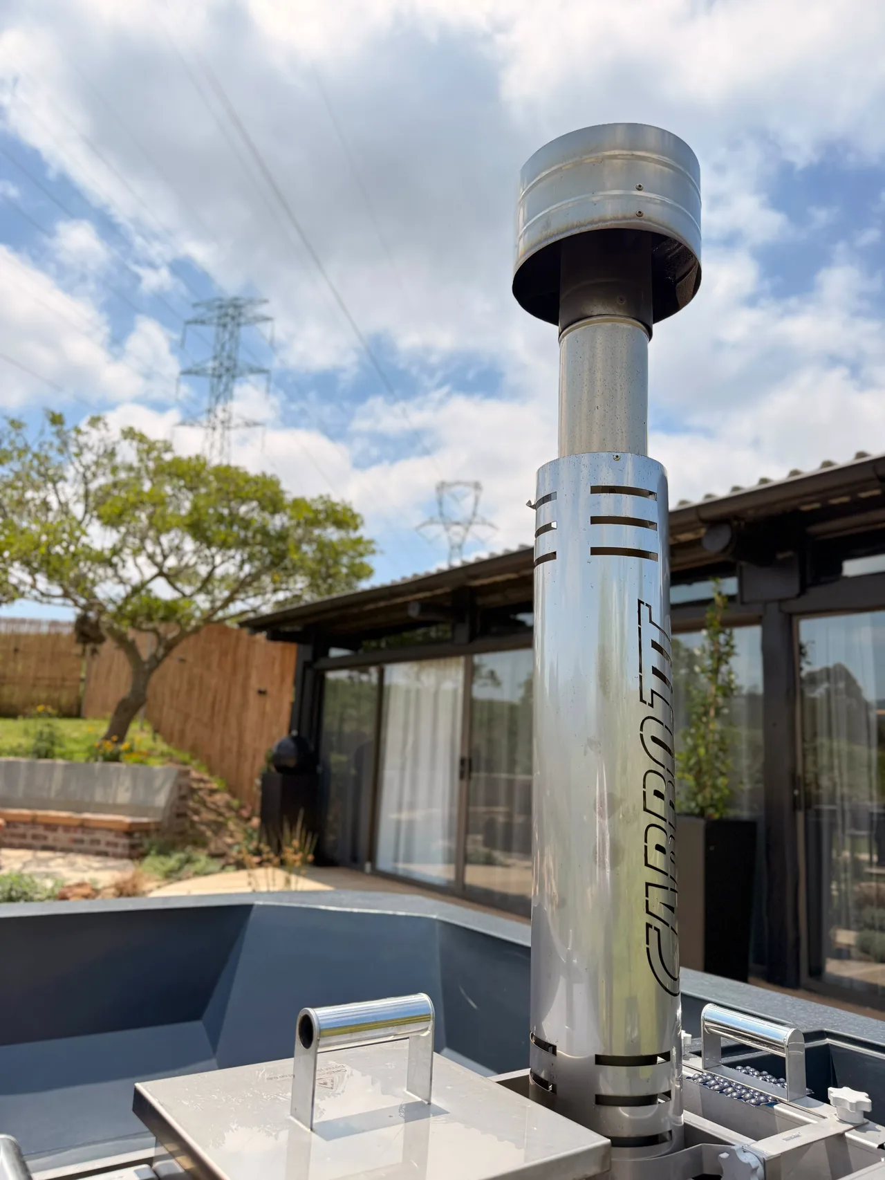 Garden suite — Stainless steel flue of the hot tub beside the suite terrace