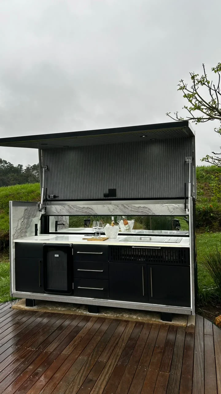 The Rover mobile outdoor kitchen with its canopy raised on a timber deck