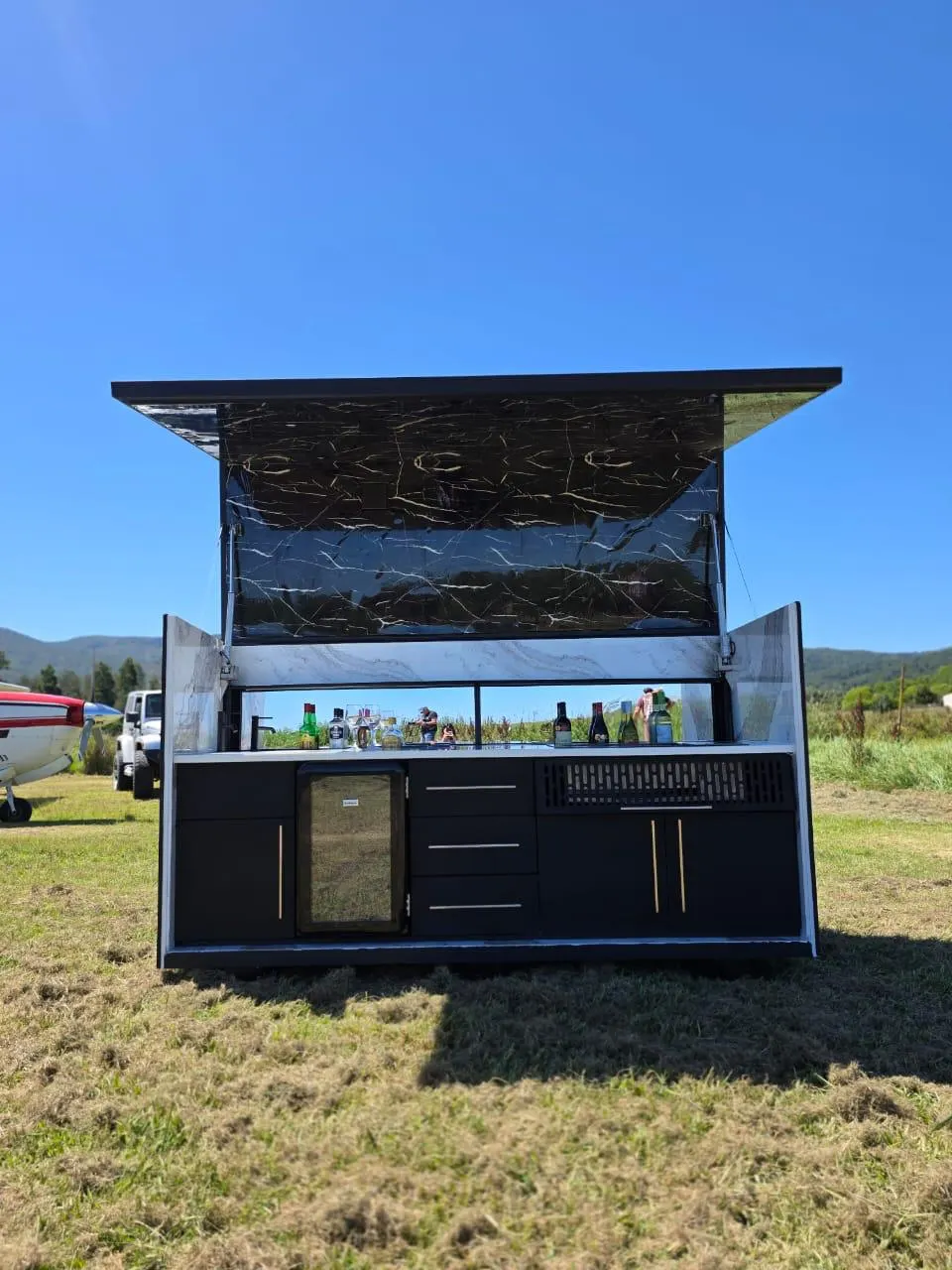 The Rover outdoor kitchen with its marble canopy raised