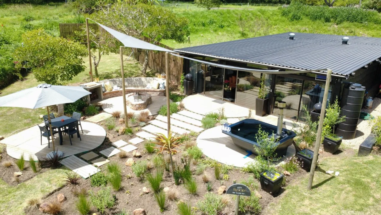 Experience suite with a garden deck, fire pit, hot tub and shade sails