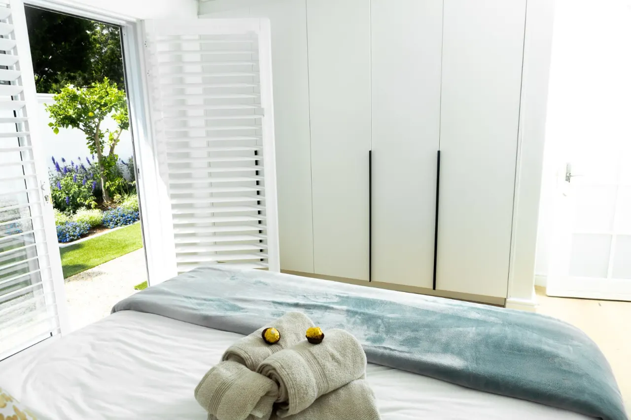 Bedroom with garden views through shuttered doors