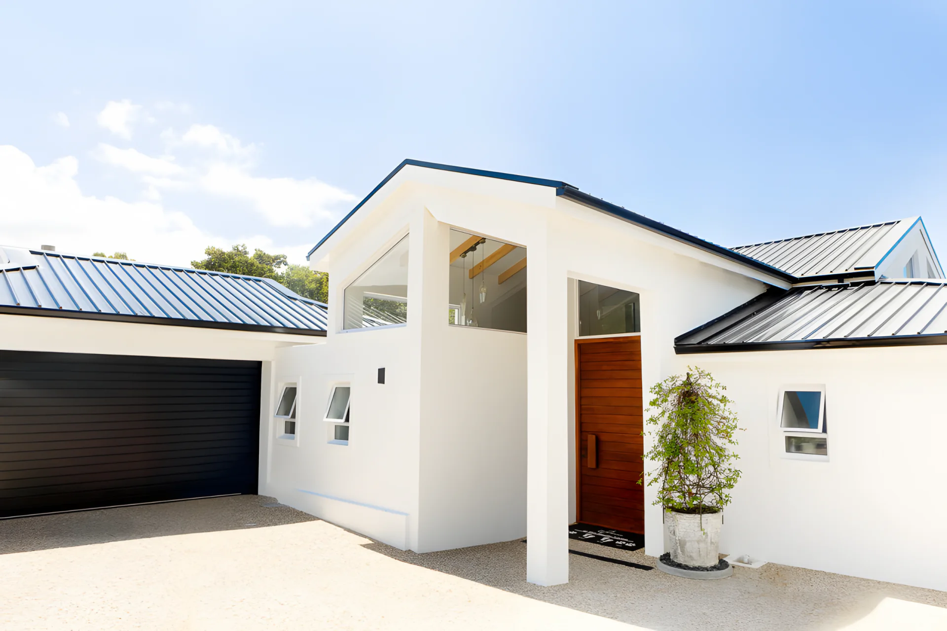 Front of the Westlake house with pivot door and garage
