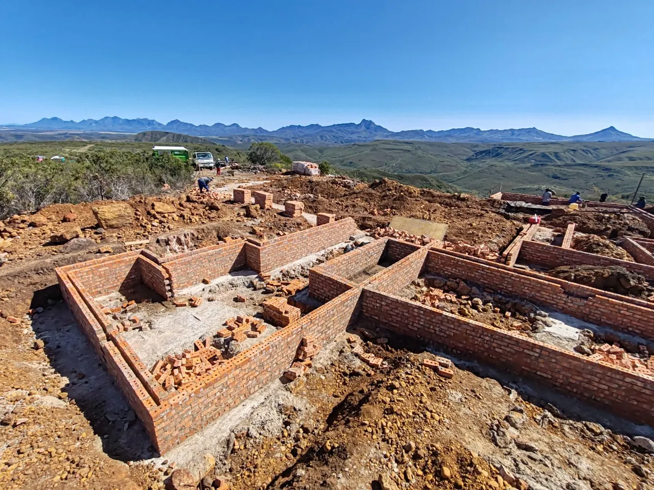 Brick footings on the lodge site with mountains beyond