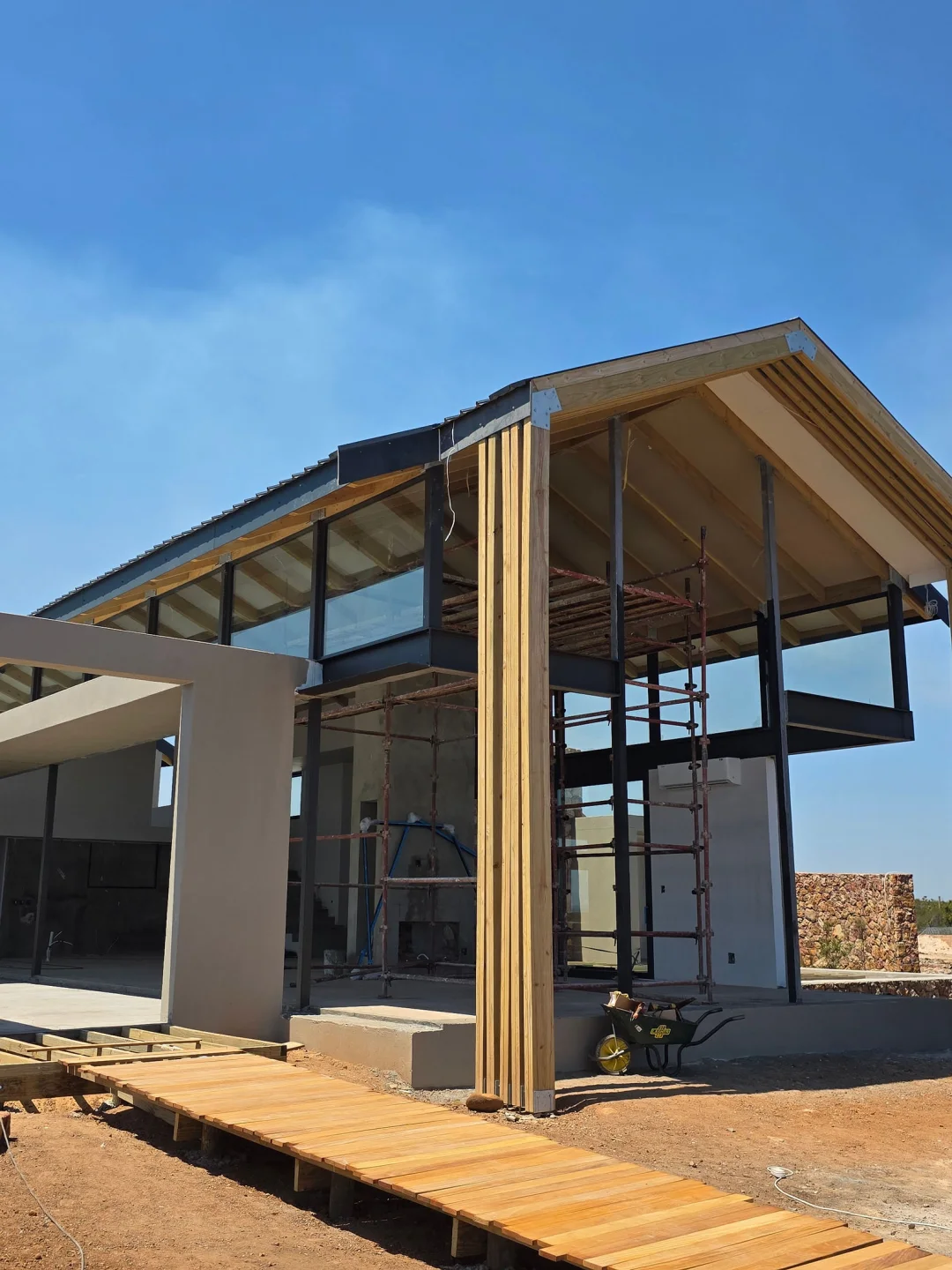Steel and timber gable frame of a lodge suite going up on site