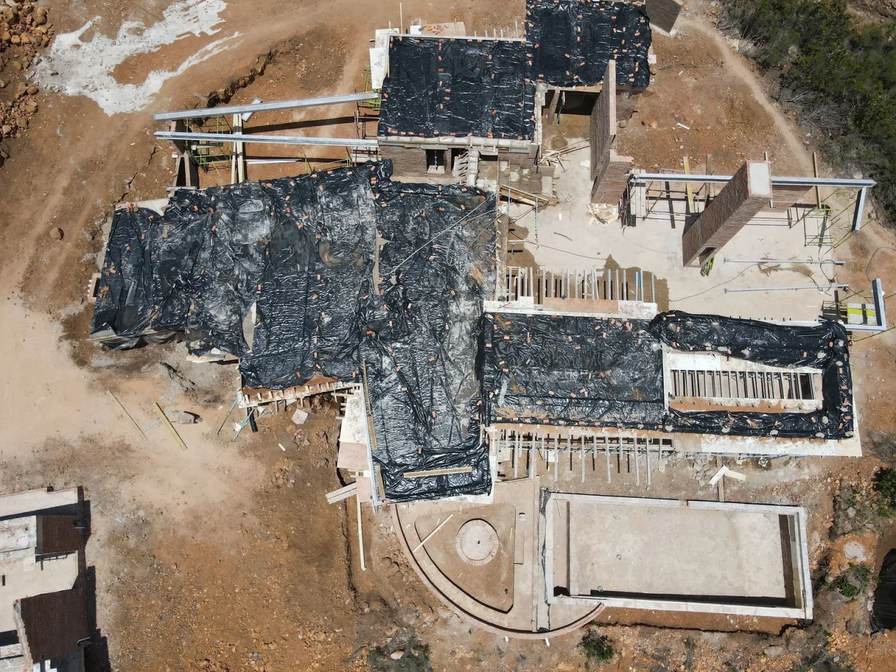 Aerial of the lodge suites under roof, with the site laid out around them