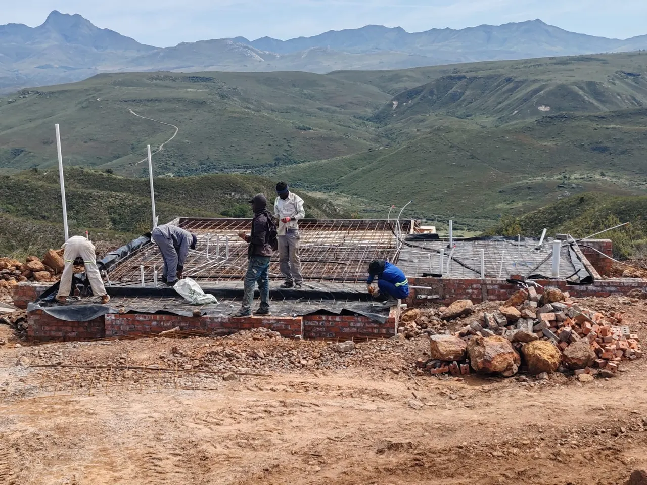 Crew preparing reinforcement for a concrete slab on site