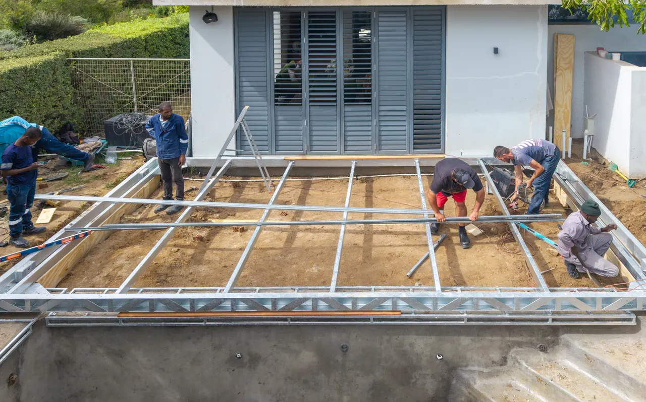 Installers levelling the steel frame of a sliding deck